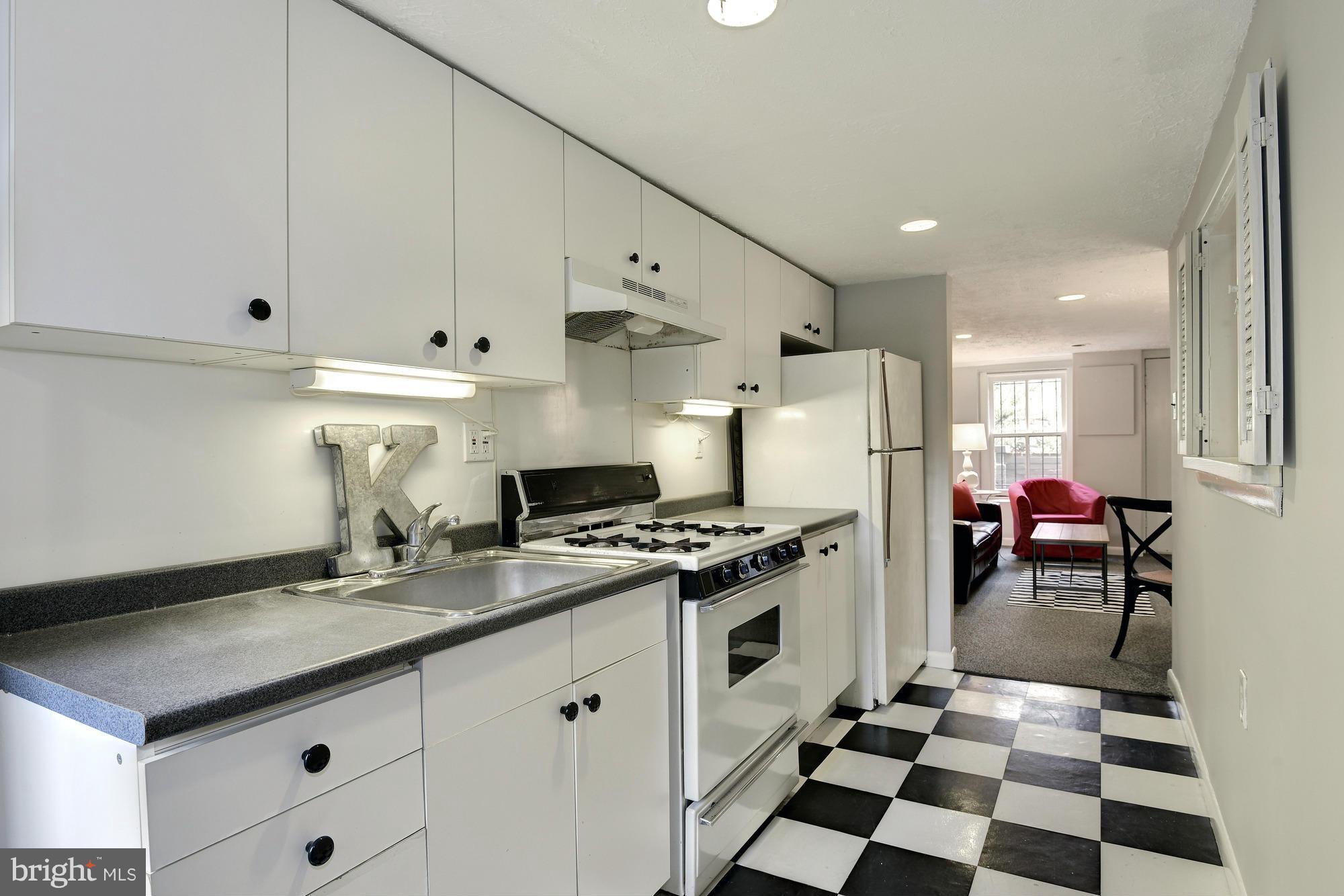 1351 A Street Northeast Washington, DC 20002 - Photo 19 of 26 a kitchen with a stove a refrigerator and a sink