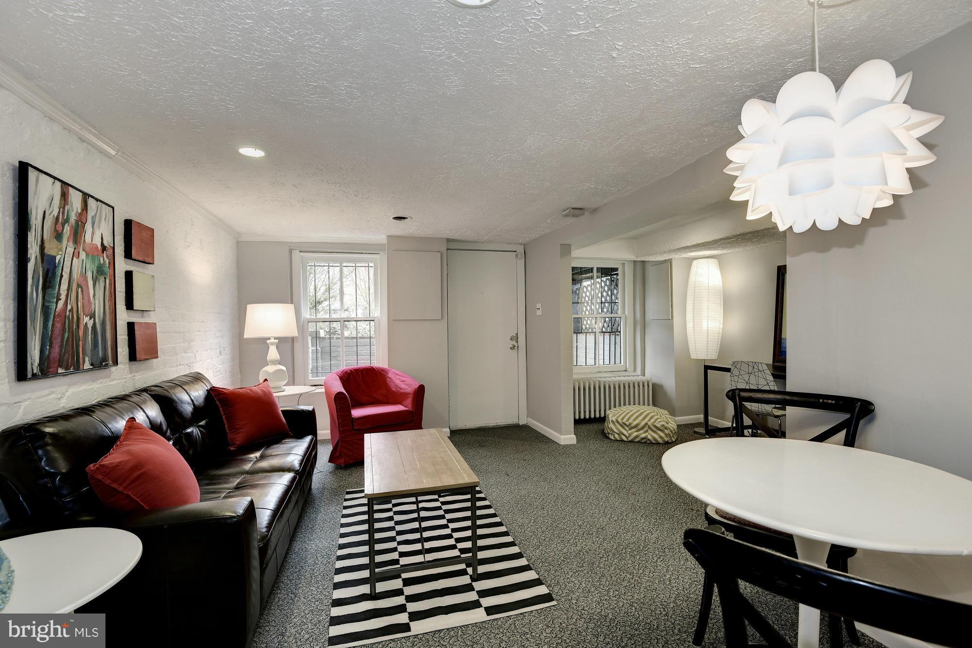 1351 A Street Northeast Washington, DC 20002 - Photo 20 of 26 a living room with furniture potted plant and a chandelier