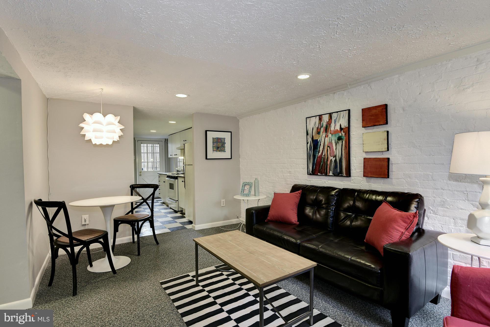 1351 A Street Northeast Washington, DC 20002 - Photo 21 of 26 a living room with furniture a rug and a window
