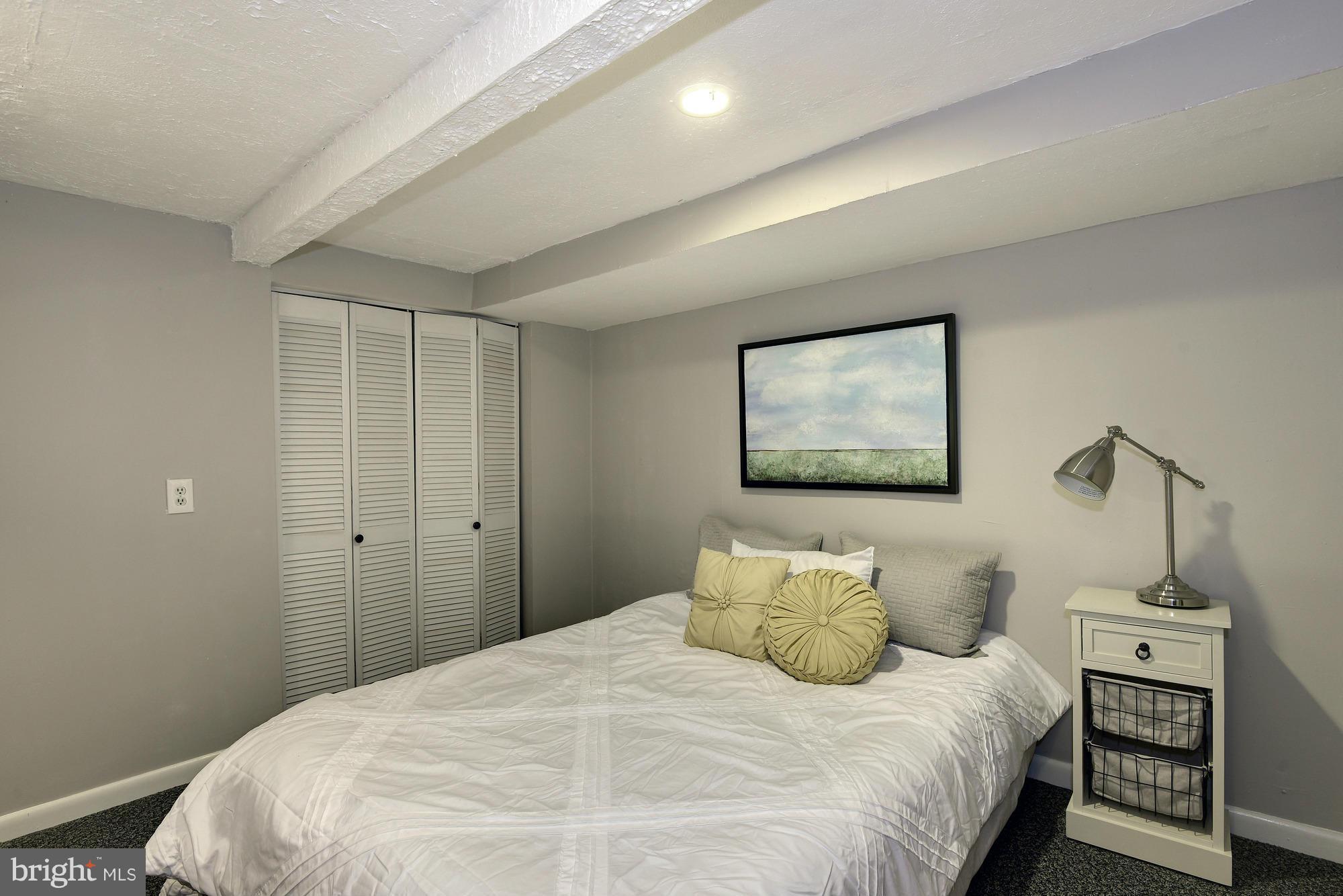 1351 A Street Northeast Washington, DC 20002 - Photo 22 of 26 a bedroom with a bed and a night stand