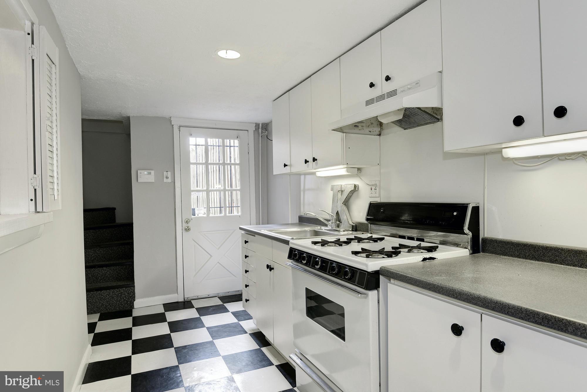 1351 A Street Northeast Washington, DC 20002 - Photo 24 of 26 a kitchen with granite countertop a stove a sink and a refrigerator