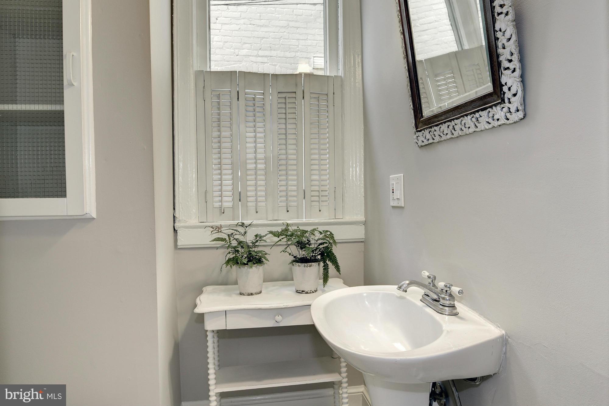 1351 A Street Northeast Washington, DC 20002 - Photo 9 of 26 a bathroom with a sink and a mirror