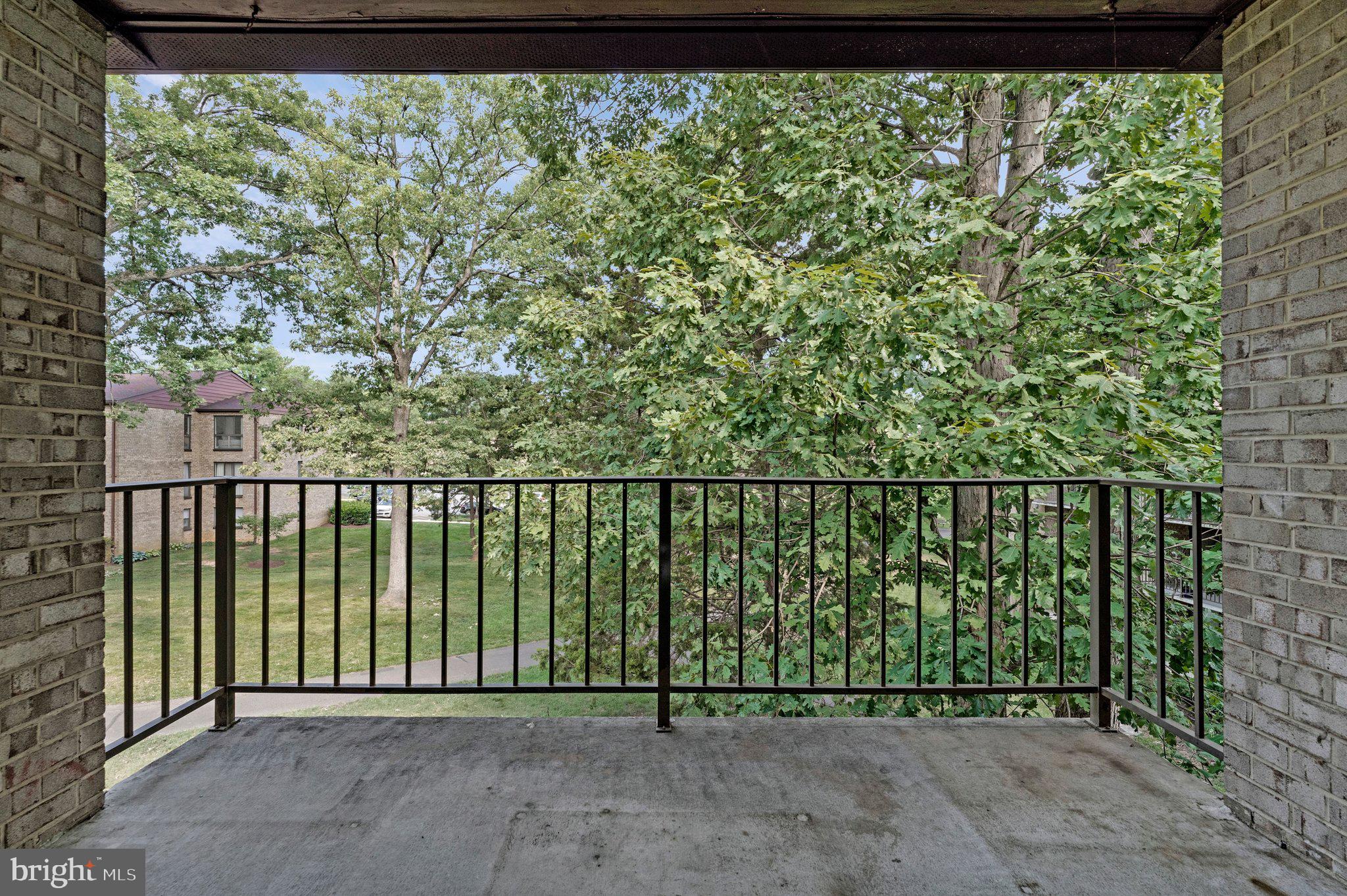 2012 Colts Neck Road, Unit 21A Reston, VA 20191 - Photo 28 of 44 Serene balcony with lush greenery view.