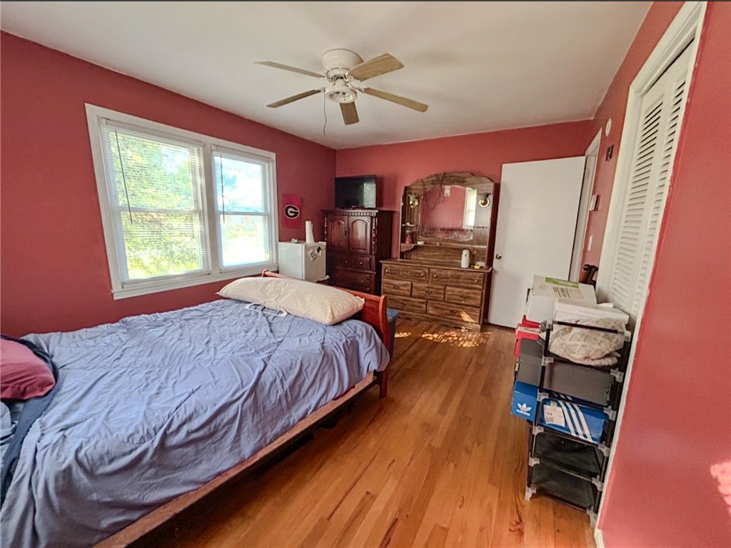 206 Collingwood Drive Anderson, SC 29621 - Photo 14 of 23 This inviting bedroom features rich hardwood flooring and a ceiling fan, creating a comfortable living space.