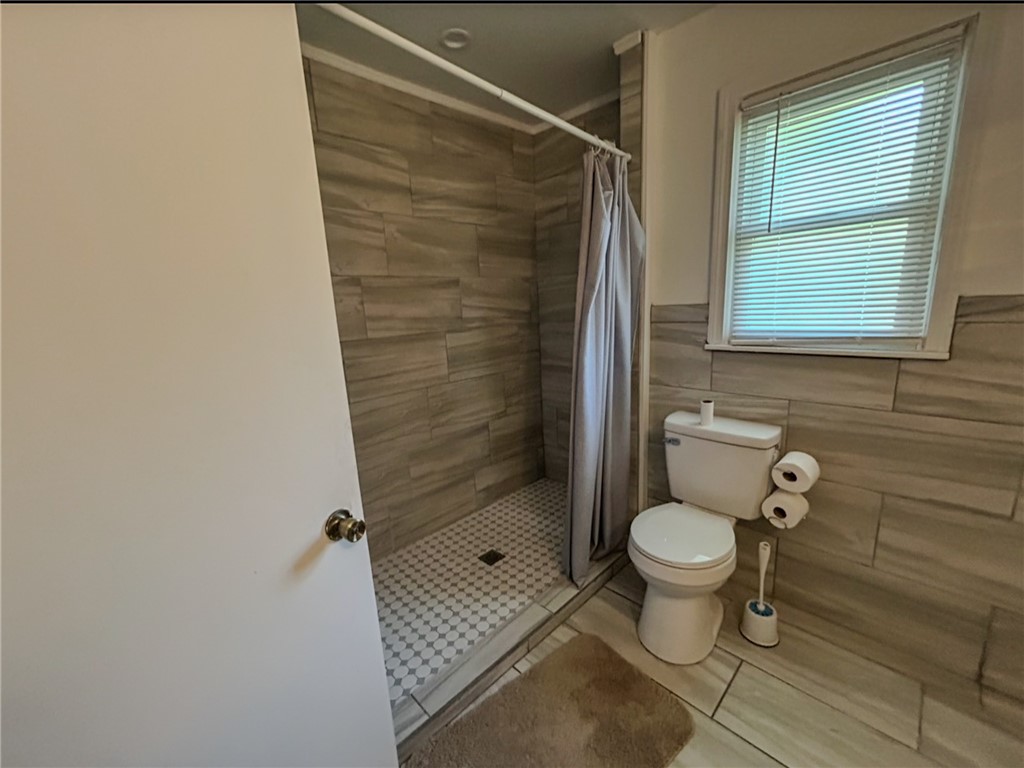 206 Collingwood Drive Anderson, SC 29621 - Photo 15 of 23 This modern bathroom features a tiled shower and floors, offering a clean and functional space.