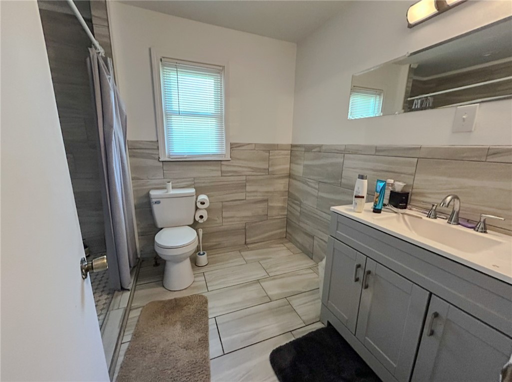 206 Collingwood Drive Anderson, SC 29621 - Photo 16 of 23 This bathroom features contemporary tile work and a sleek vanity, offering a serene retreat.