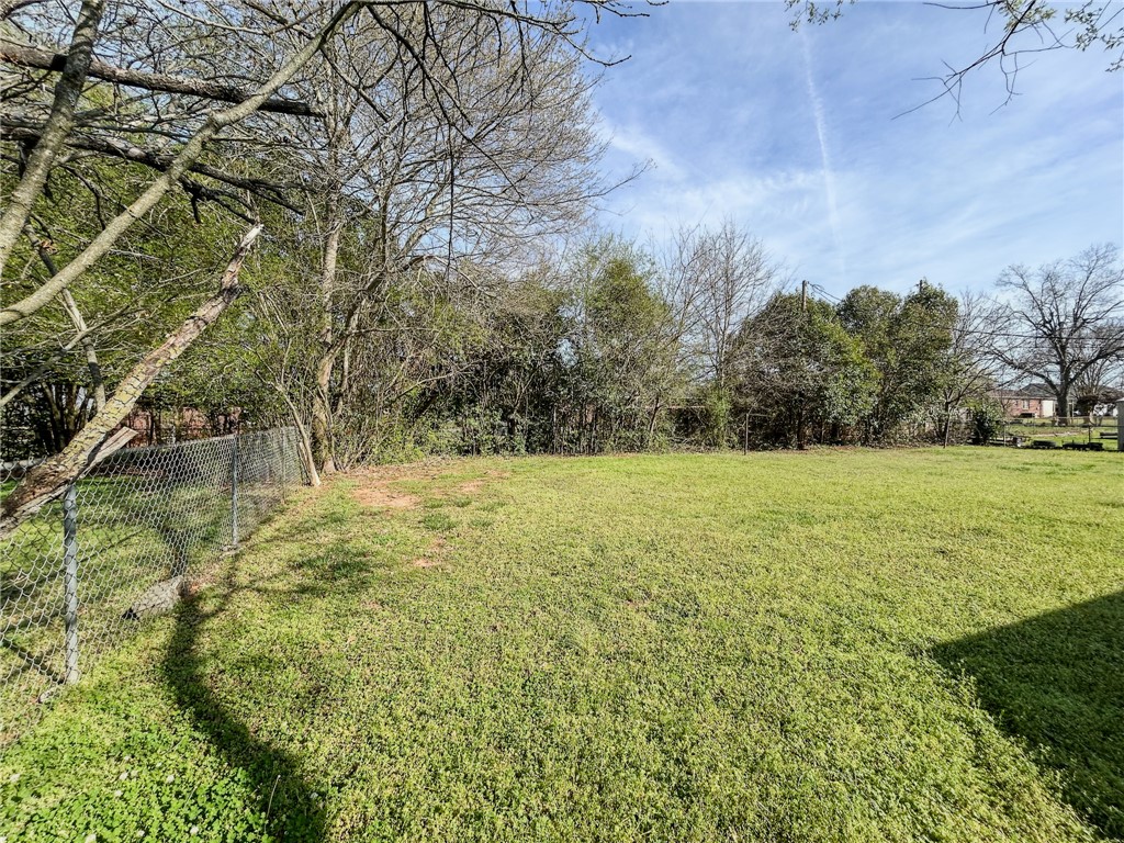 206 Collingwood Drive Anderson, SC 29621 - Photo 21 of 23 A spacious yard with natural fencing, offering ample room for outdoor activities.