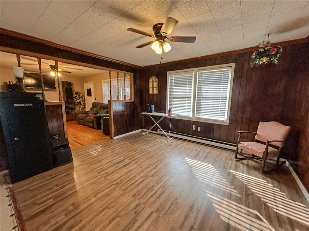 206 Collingwood Drive Anderson, SC 29621 - Photo 6 of 23 This versatile living space features wood paneling and bright windows, ready for personalization.