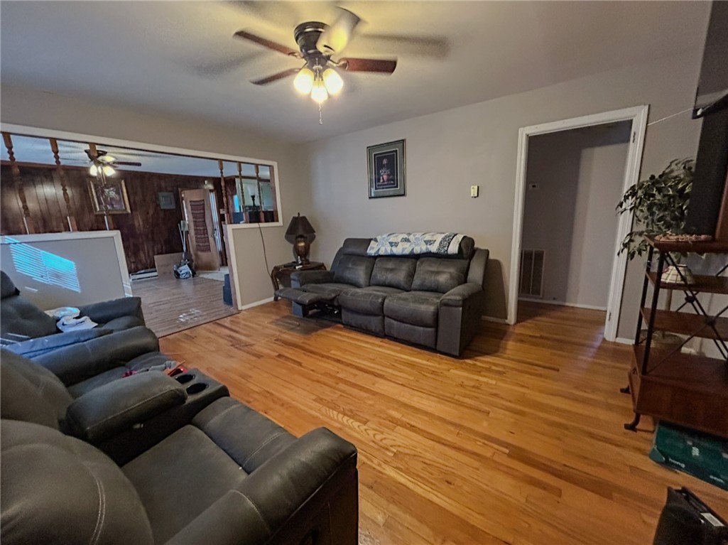 206 Collingwood Drive Anderson, SC 29621 - Photo 8 of 23 Bright hardwood floors and a ceiling fan elevate this welcoming living space.