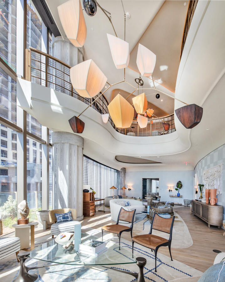 1333 South Flagler Drive, Unit 1001 West Palm Beach, FL 33401 - Photo 12 of 20 a living room with furniture a chandelier and a large window