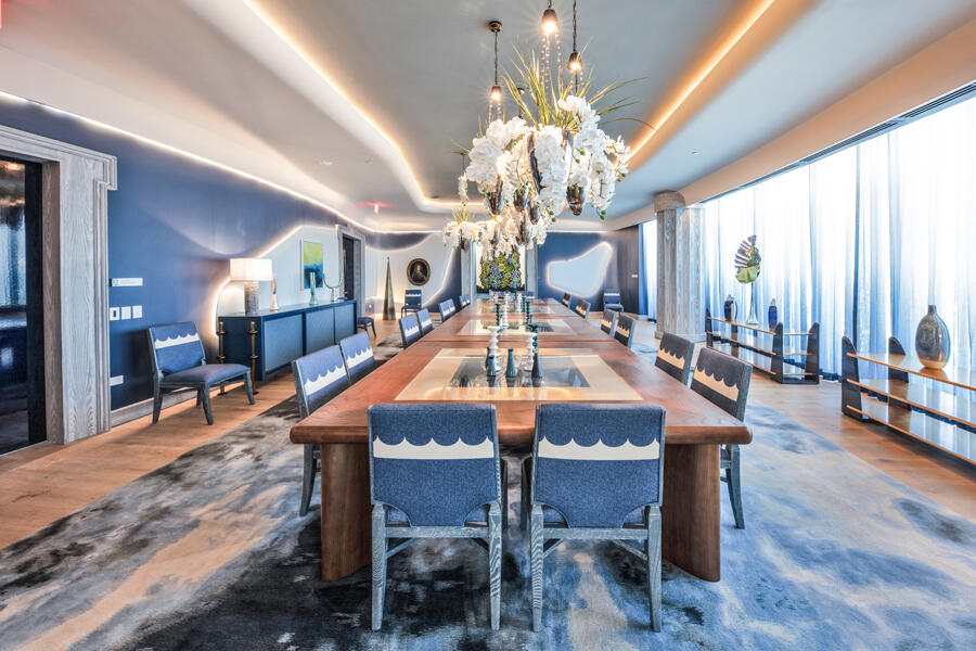 1333 South Flagler Drive, Unit 1001 West Palm Beach, FL 33401 - Photo 16 of 20 a dining room with wooden floor a chandelier a wooden table and chairs