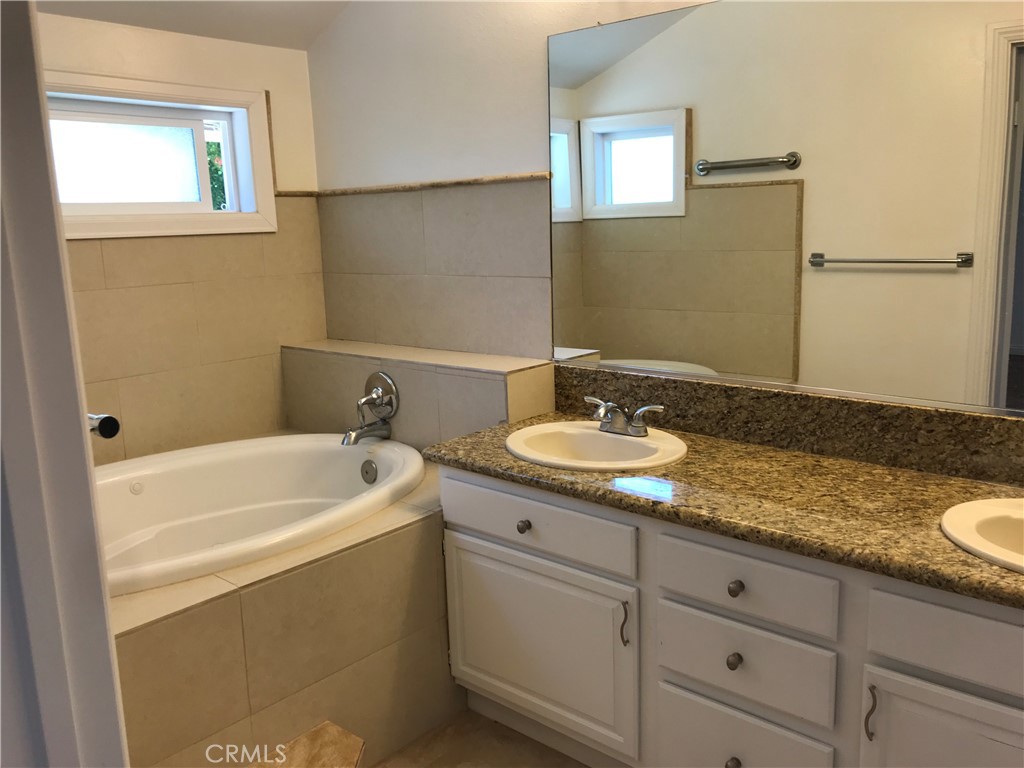 3 Morris Road Irvine, CA 92620 - Photo 14 of 24 a bathroom with a granite countertop sink and a bathtub