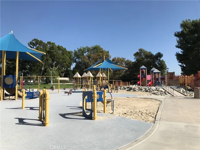 a view of a patio with a table and chairs under an umbrella