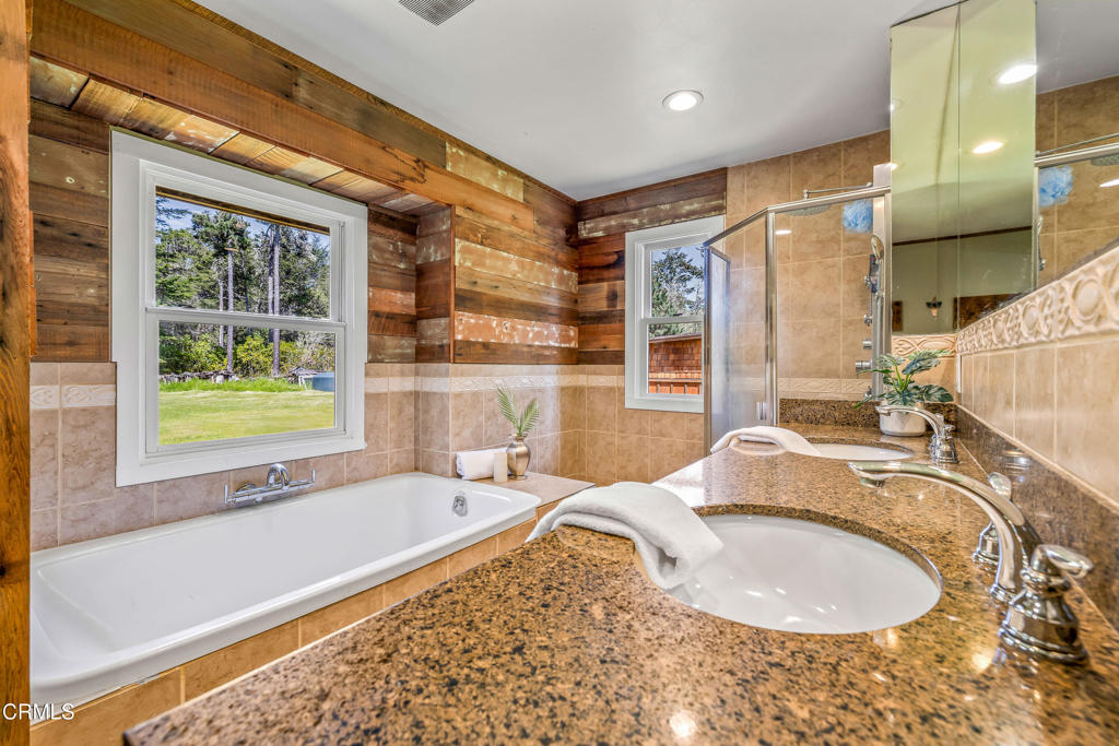 41912 Powers Road Mendocino, CA 95460 - Photo 20 of 48 a en suite bathroom with a granite countertop tub and a sink