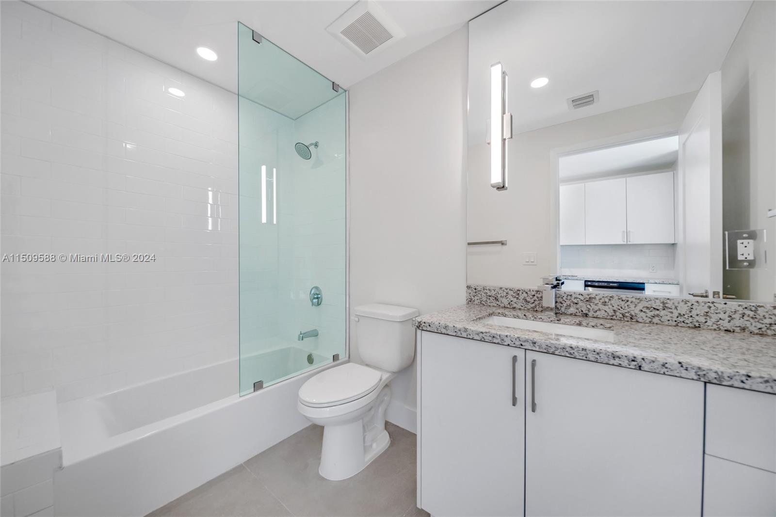 Civic Center Miami, FL 33125 - Photo 14 of 19 a bathroom with a granite countertop sink toilet and shower