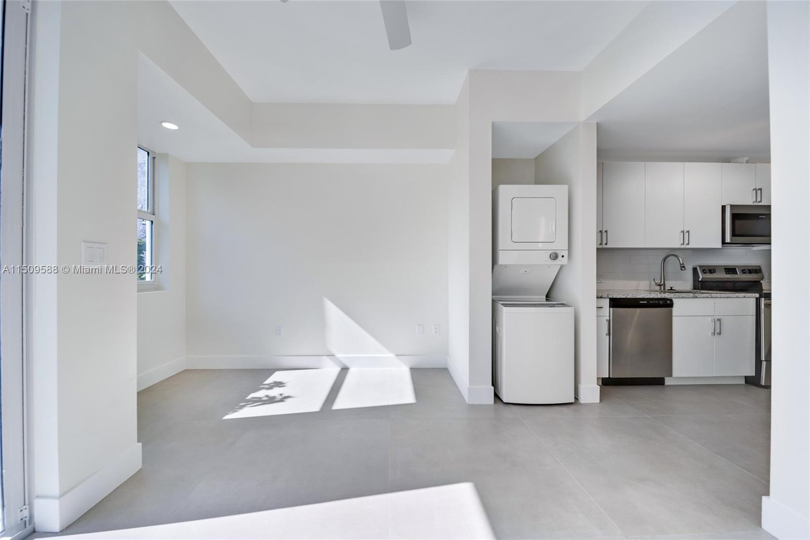 Civic Center Miami, FL 33125 - Photo 18 of 19 a view of kitchen with refrigerator and white cabinets