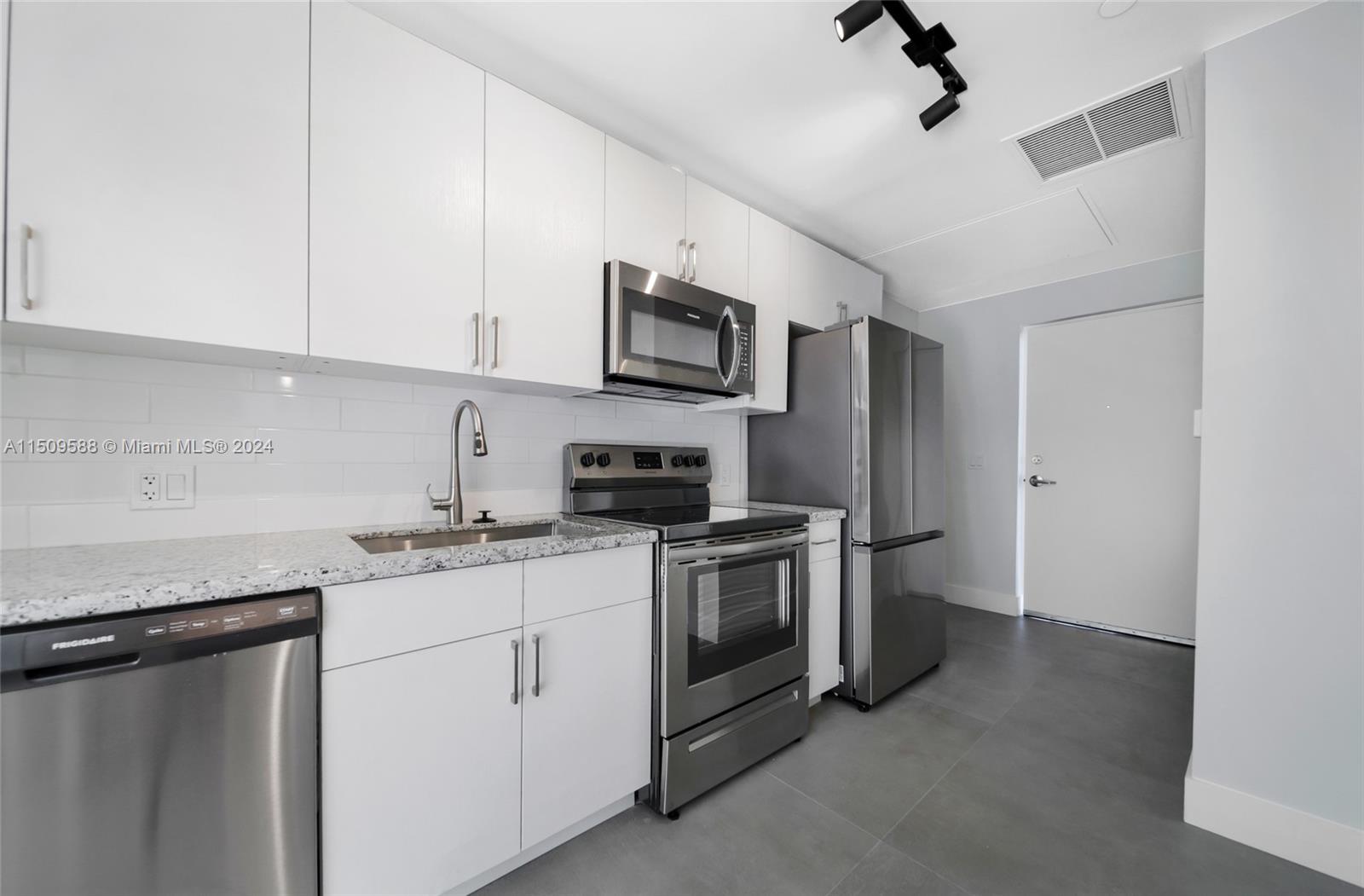 Civic Center Miami, FL 33125 - Photo 6 of 19 a kitchen with stainless steel appliances granite countertop a stove a sink and a refrigerator