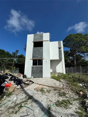 a view of backyard with barbeque grill and potted plants