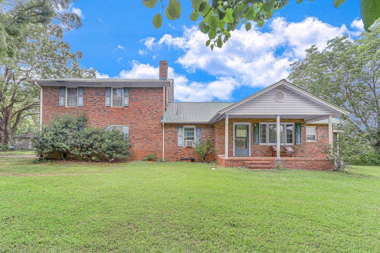 357 New House Road Canon, GA 30520 - Photo 1 of 1 a front view of a house with a garden