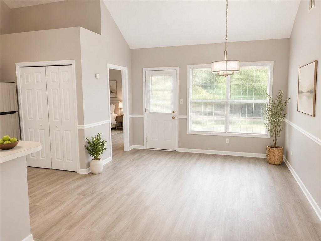 865 McDonough Road Hampton, GA 30228 - Photo 4 of 8 a view of an empty room with a window and wooden floor