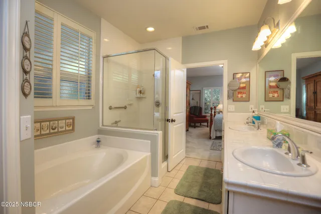 a living room with furniture a rug and a bookshelf