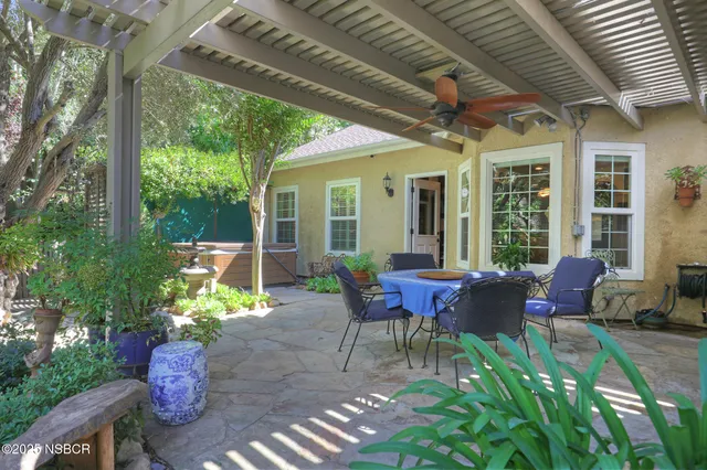 a backyard of a house with outdoor seating