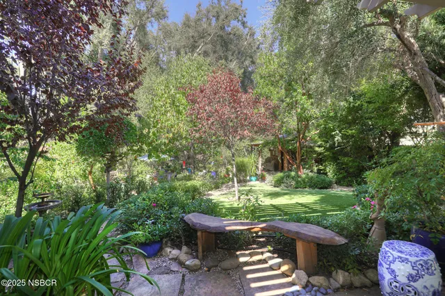 a big yard with lots of green space and deers