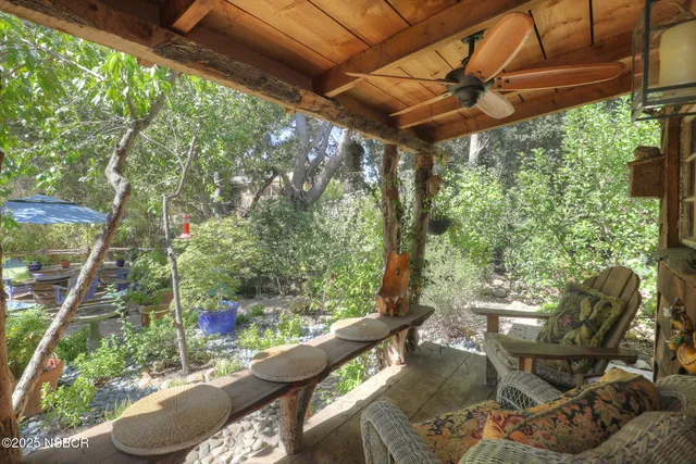 a backyard of a house with yard and outdoor seating