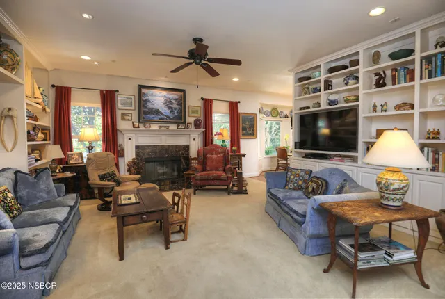 a dining room with furniture a chandelier and wooden floor