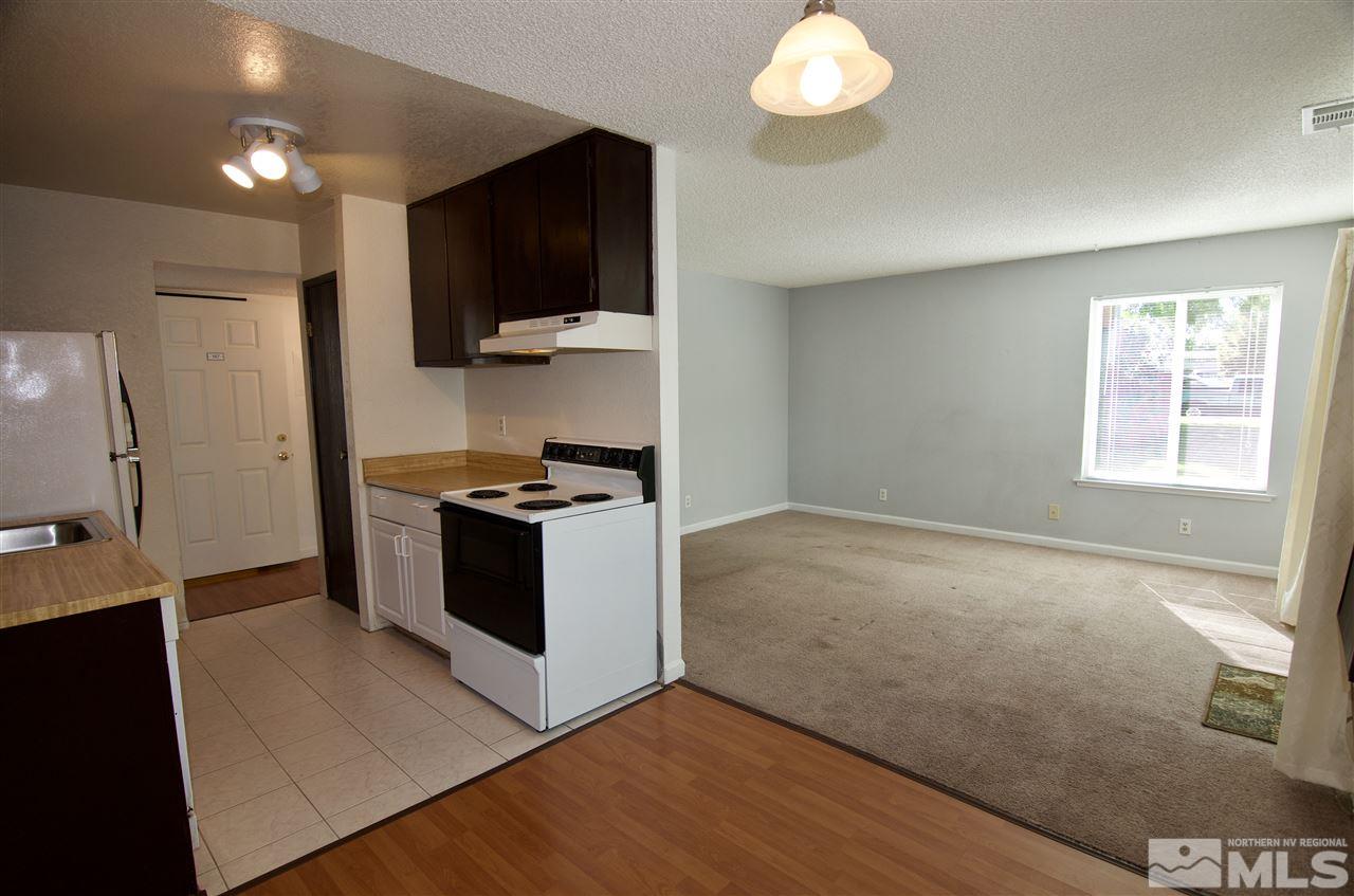 4606 Neil Road, Unit 167 Reno, NV 89502 - Photo 8 of 25 a kitchen with stainless steel appliances granite countertop a stove and a microwave