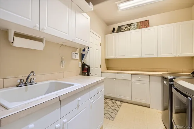 a kitchen with a sink cabinets and a window