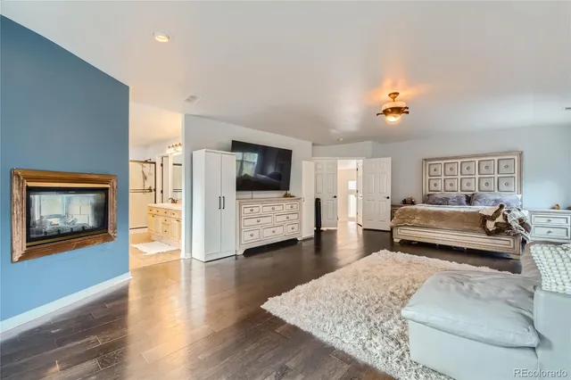 a bedroom with furniture and a flat screen tv