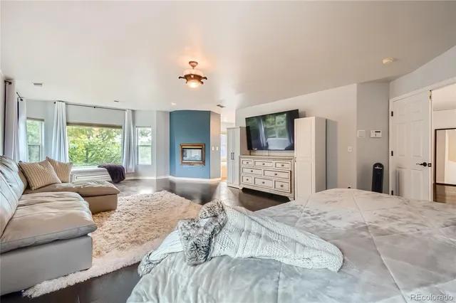 a large bedroom with a large bed and a couch