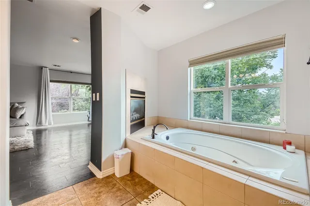 a bathroom with a bathtub and a window
