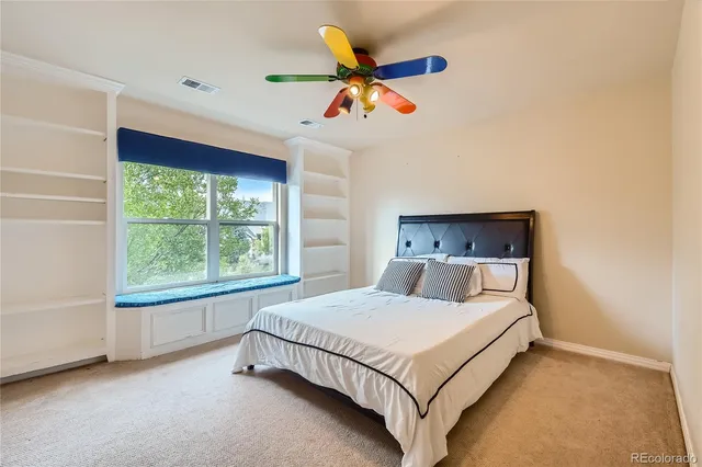 a bedroom with a bed and window