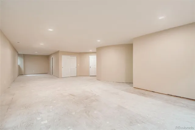 a view of an empty room with a kitchen