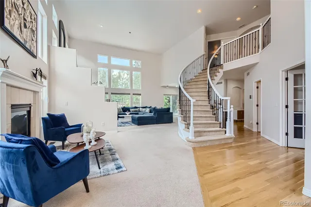 a living room with furniture and stairs