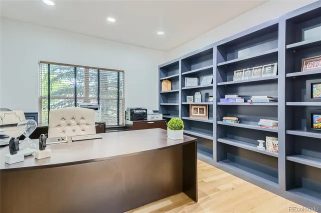 a living room with furniture and a book shelf