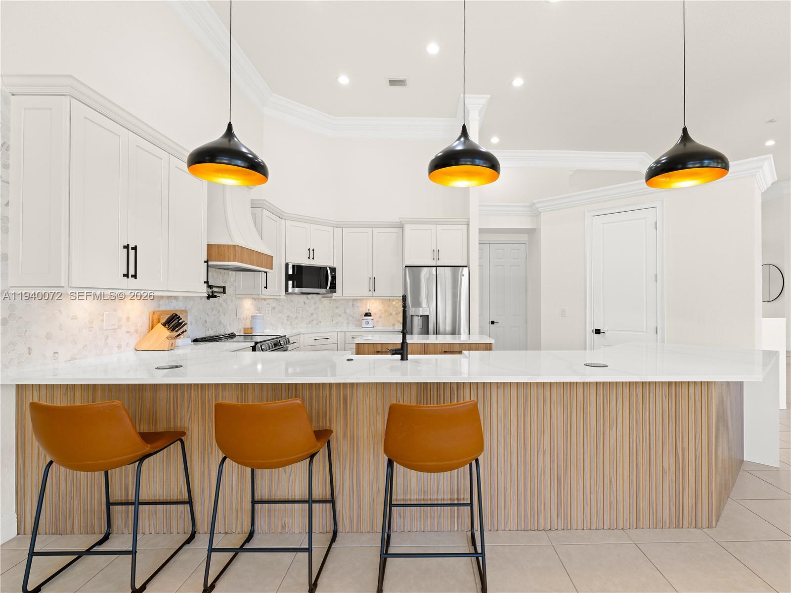 15016 Southwest 35th Street Davie, FL 33331 - Photo 12 of 50 a kitchen with stainless steel appliances granite countertop a sink a stove and a refrigerator