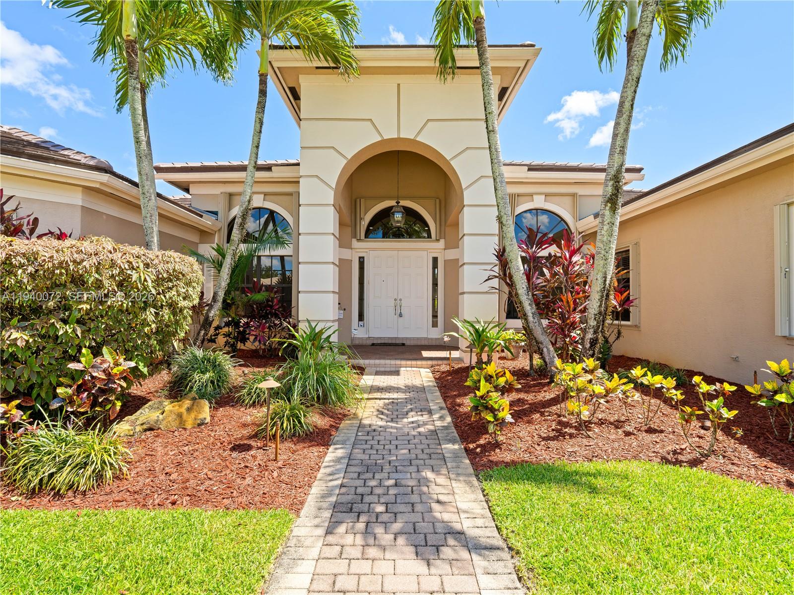 15016 Southwest 35th Street Davie, FL 33331 - Photo 2 of 50 a front view of a house with a garden