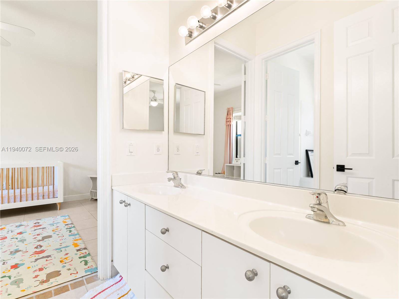 15016 Southwest 35th Street Davie, FL 33331 - Photo 29 of 50 a bathroom with a sink and a mirror