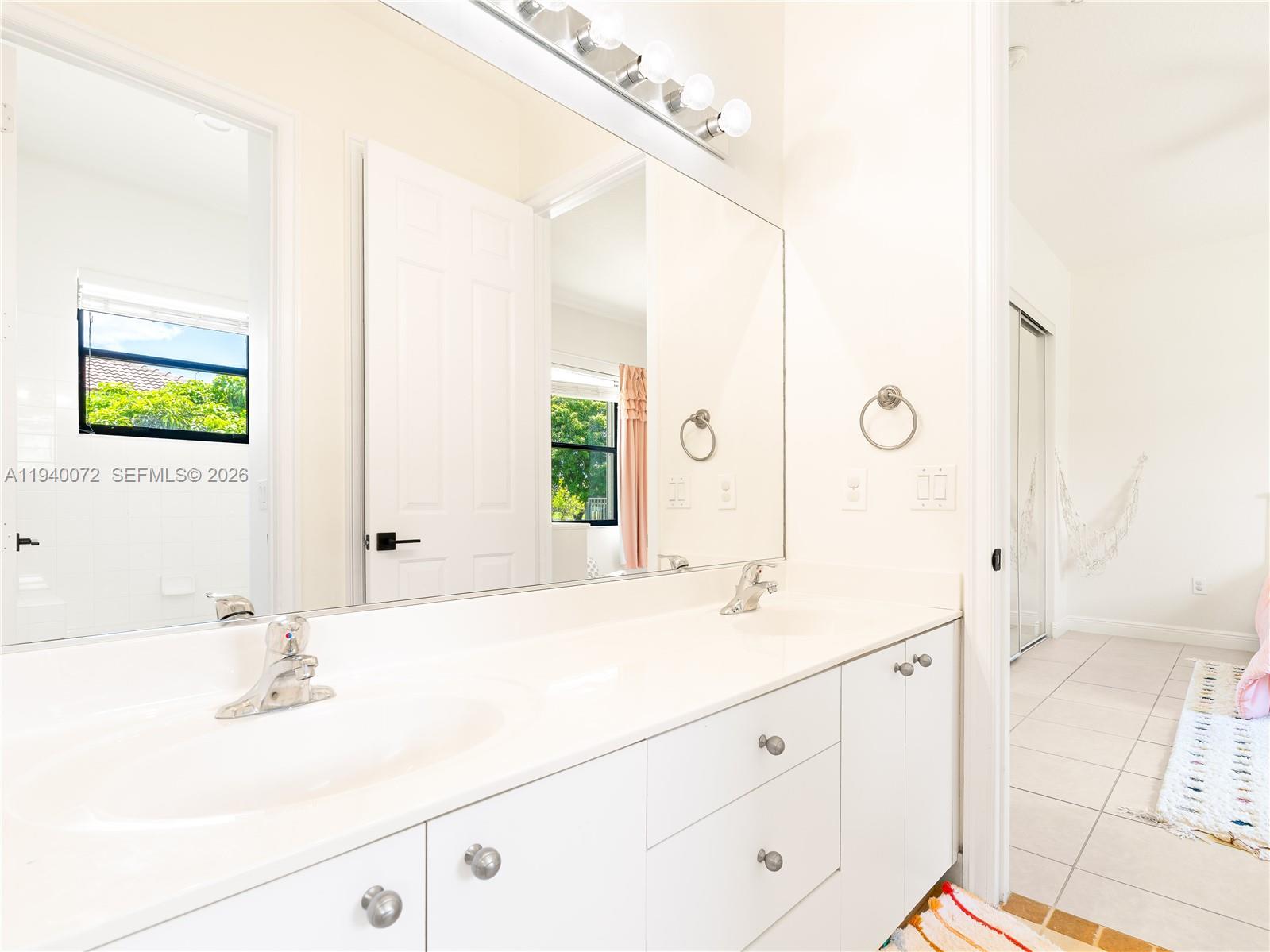 15016 Southwest 35th Street Davie, FL 33331 - Photo 30 of 50 a bathroom with a double vanity sink mirror and