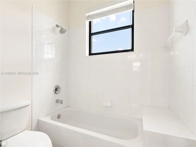 a balcony view with a potted plant and outdoor seating