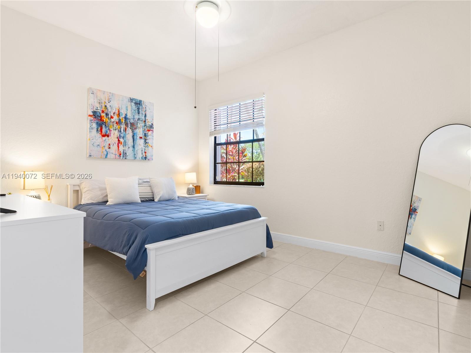 15016 Southwest 35th Street Davie, FL 33331 - Photo 35 of 50 a bedroom with a bed and a window