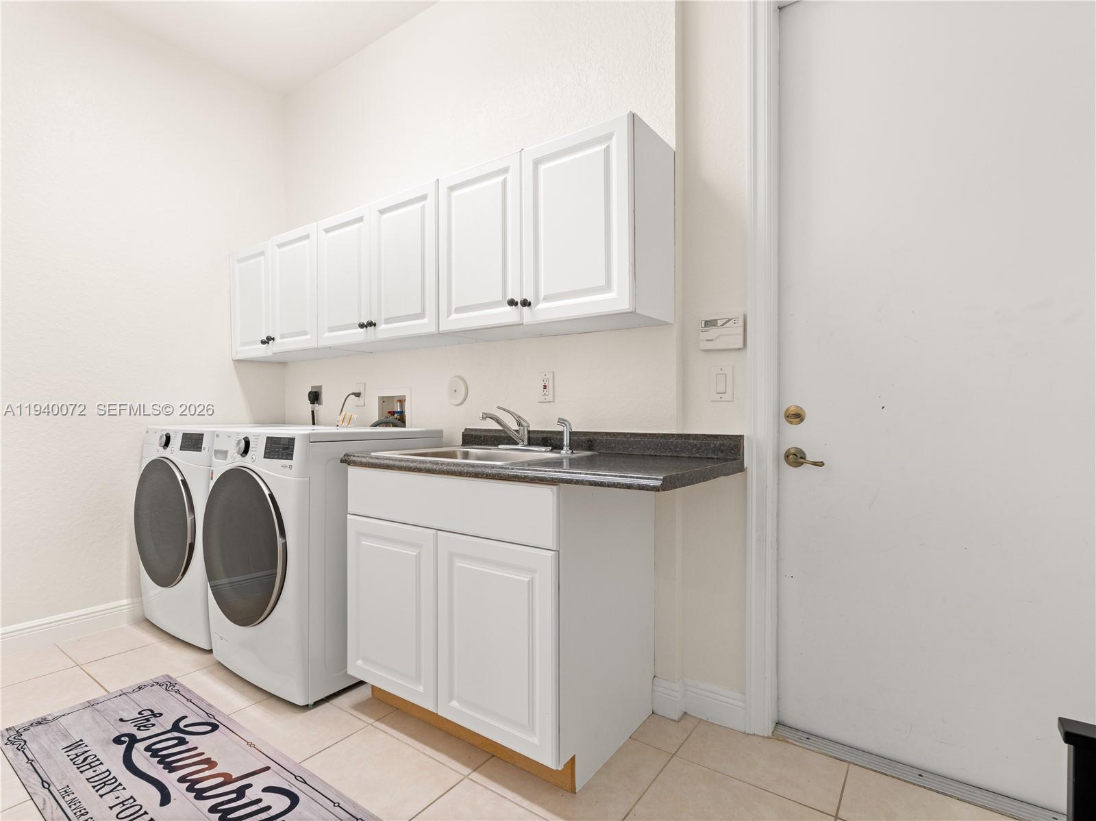 15016 Southwest 35th Street Davie, FL 33331 - Photo 36 of 50 a utility room with sink dryer and washer
