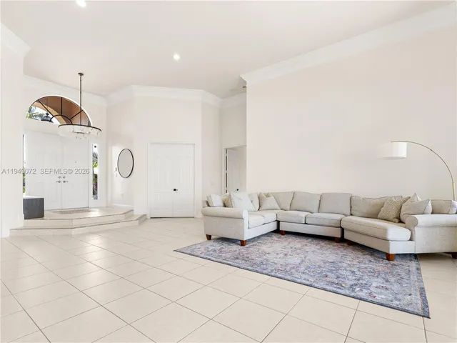 a living room with a large window and a flat screen tv