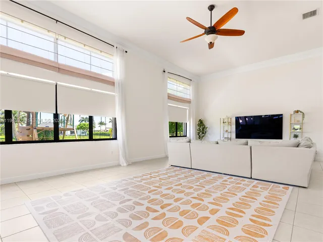 a large kitchen with kitchen island a sink a counter space and stainless steel appliances