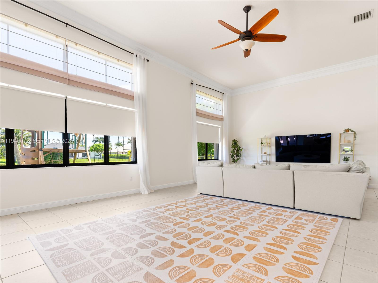 15016 Southwest 35th Street Davie, FL 33331 - Photo 8 of 50 a living room with a large window and a flat screen tv