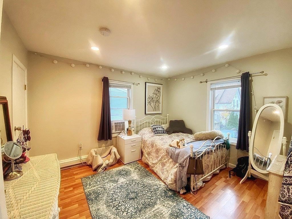 28 Francis Street, Unit 2 Waltham, MA 02451 - Photo 3 of 11 a bedroom that has a bed and a mirror in it