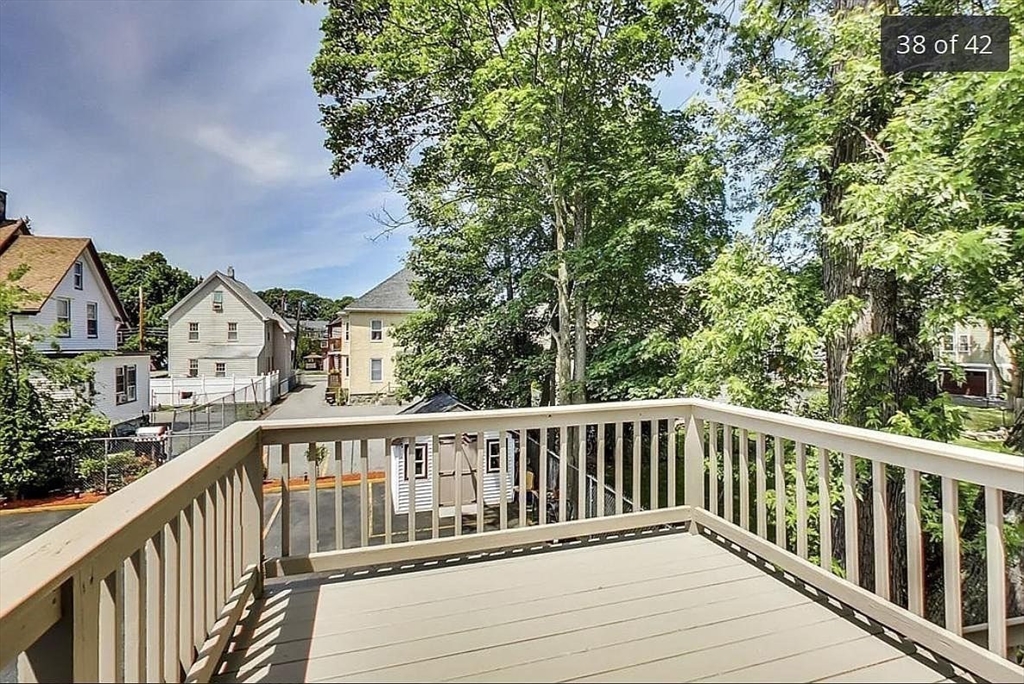 28 Francis Street, Unit 2 Waltham, MA 02451 - Photo 4 of 11 a view of balcony with wooden floor and fence
